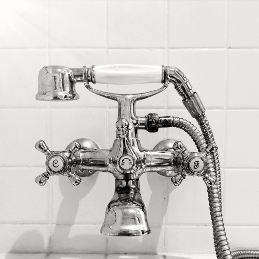 Bathroom tap over a bath with shower connected